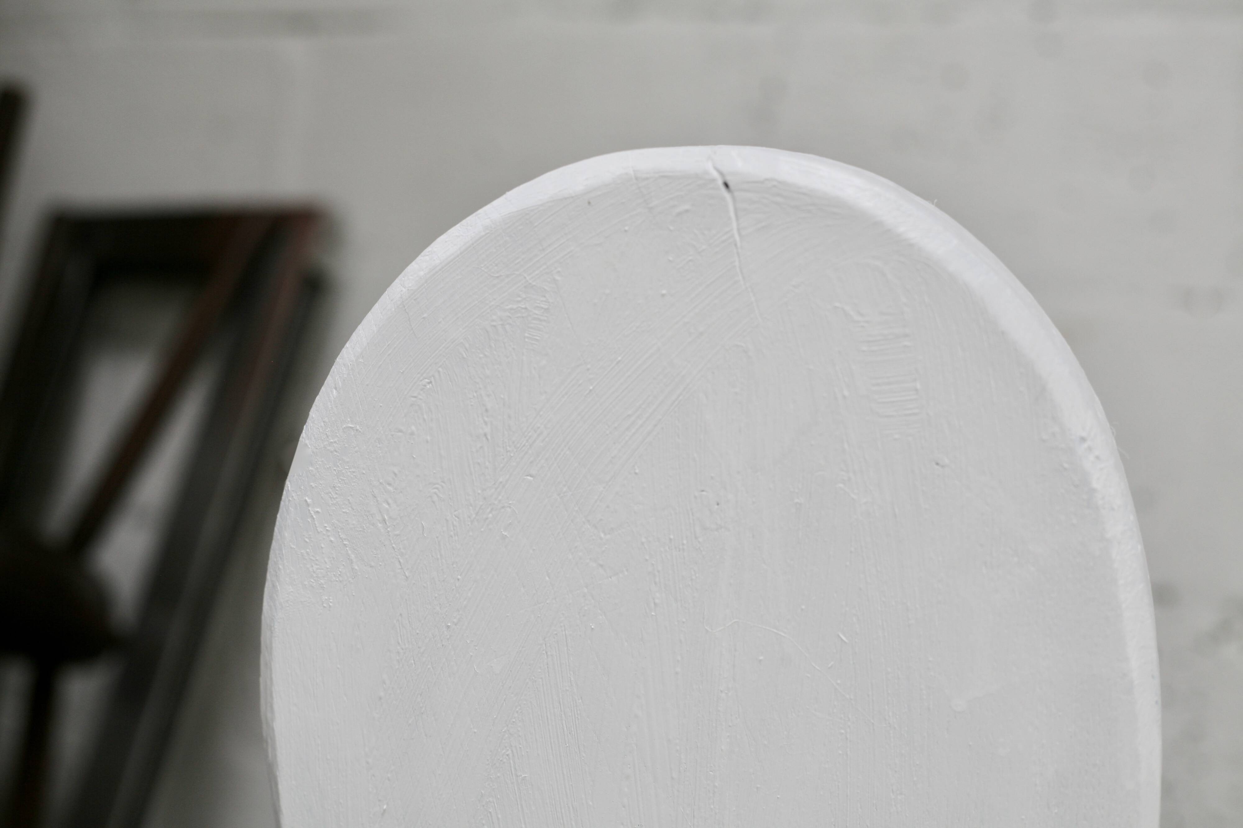 Pair of tripod chairs, gouged seats. Brutalist, circa 1960. Painted wood.