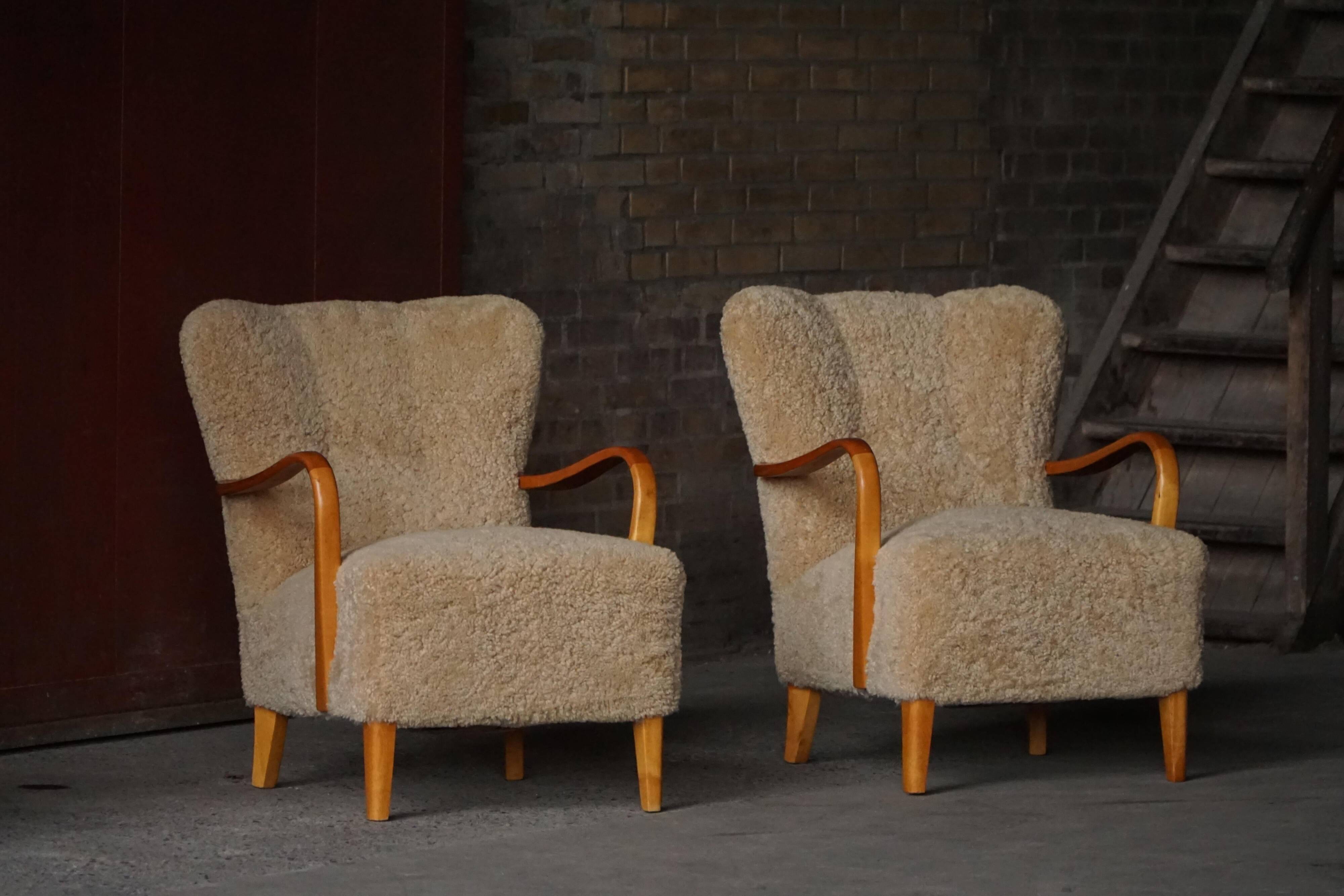 Pair of Mid Century Modern Swedish lounge chairs in birch and lamb's wool, 1960s.