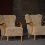 Pair of Mid Century Modern Swedish lounge chairs in birch and lamb's wool, 1960s.