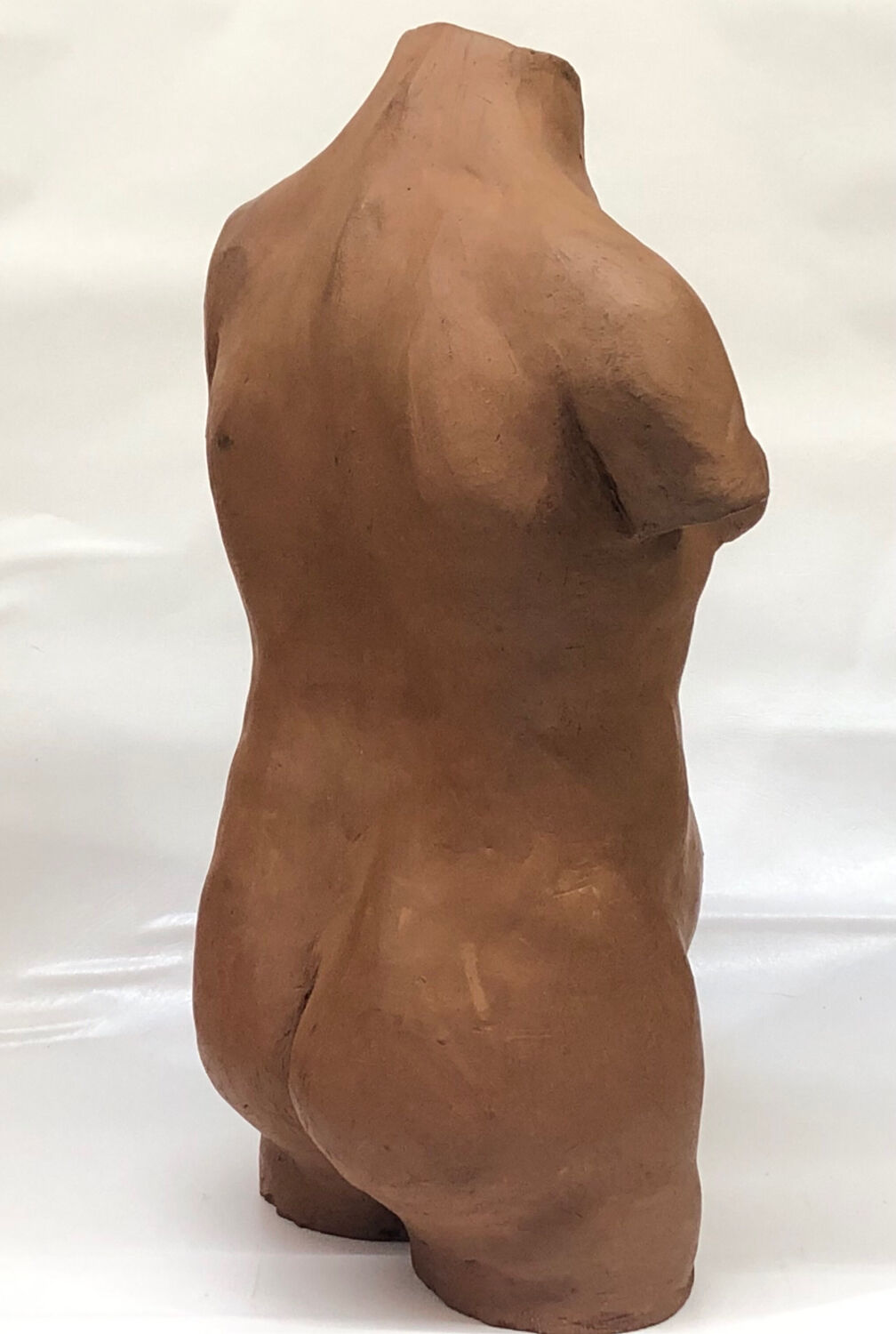School bust of a female body in red clay terracotta