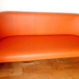 Curved vintage orange canapé with a pop spirit, seventies design piece.