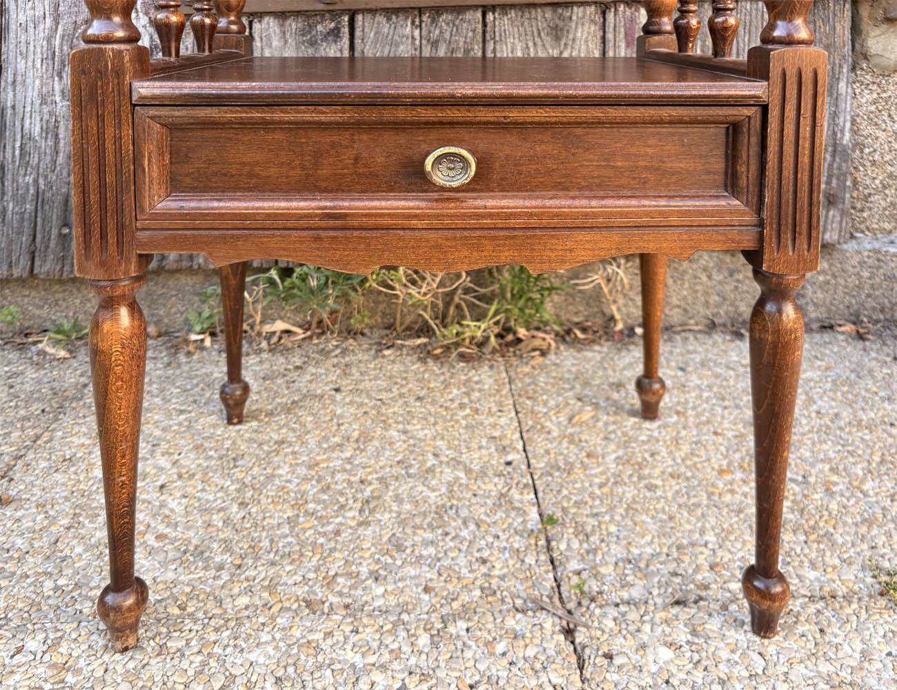 Solid wood bedside table with turned columns, early 20th century.