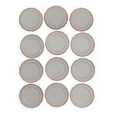 Set of 12 stylised white porcelain dinner plates, signed.