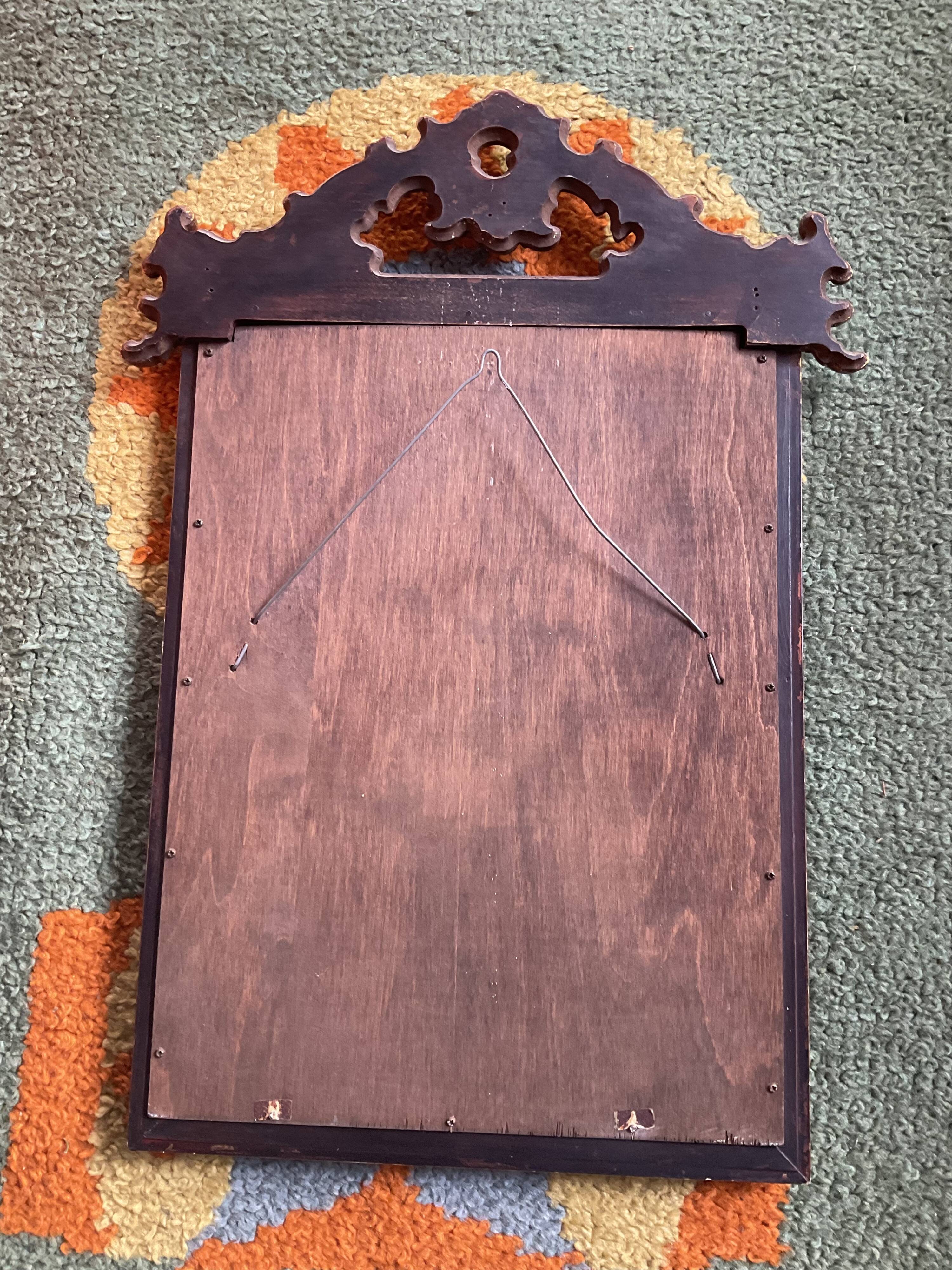Old pedimented mirror in gilded wood