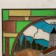 Art Deco stained glass window decorated with a 20th century church steeple