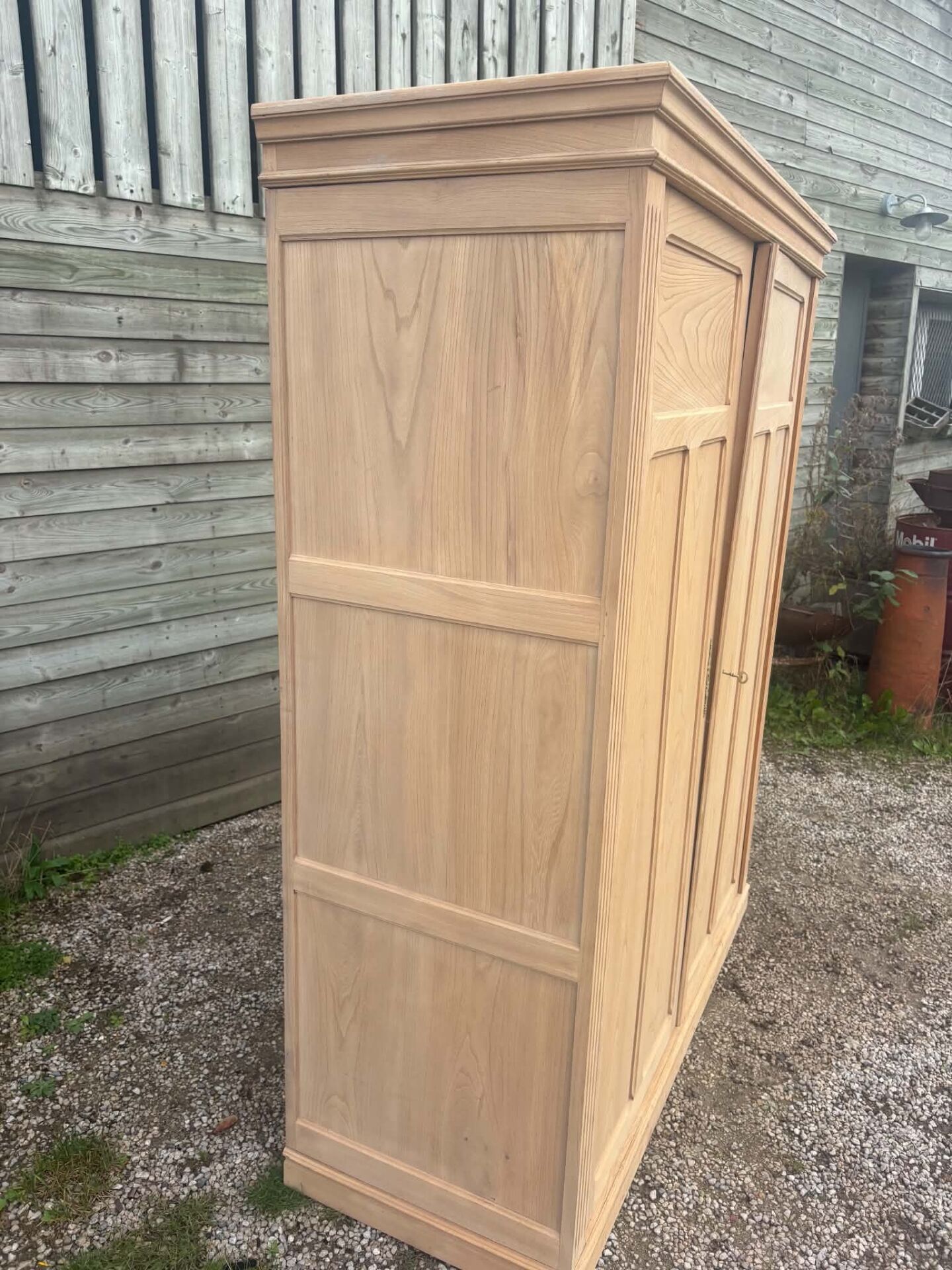 Large antique wardrobe in raw wood