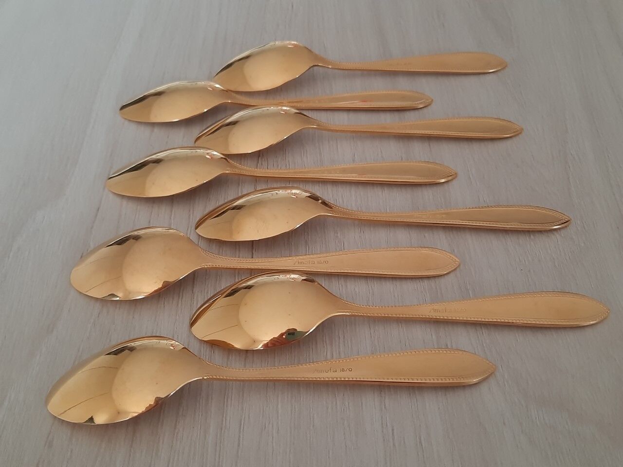 Small golden metal spoons