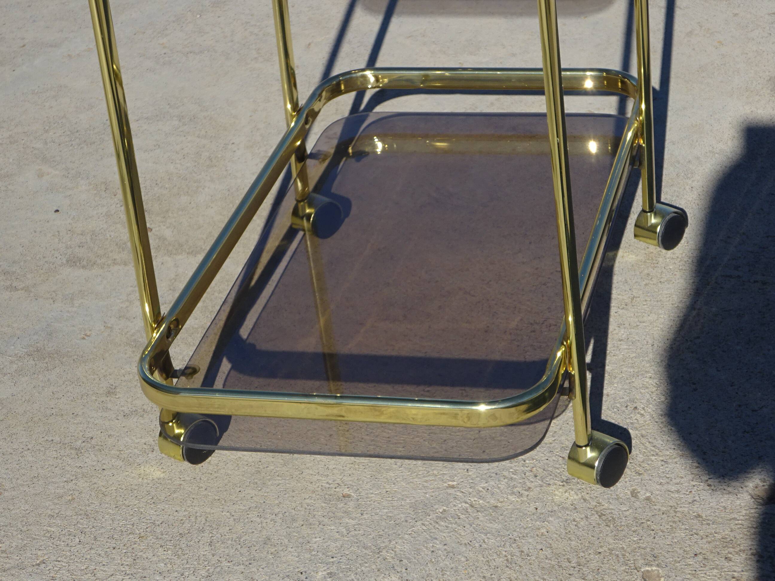 Golden metal and smoked glass dessert table