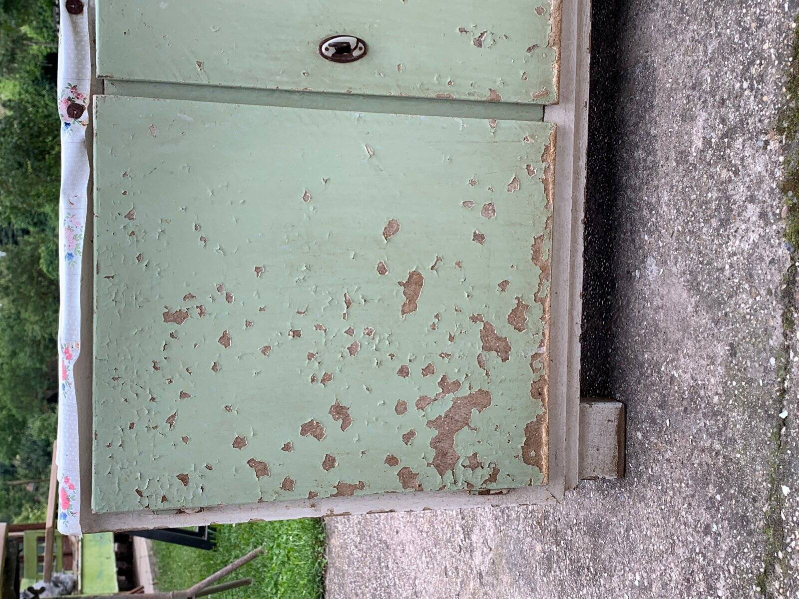 Vintage low wooden cabinet painted green and white with a floral fabric top (1950s)