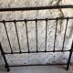 old bed with vintage painted metal bars