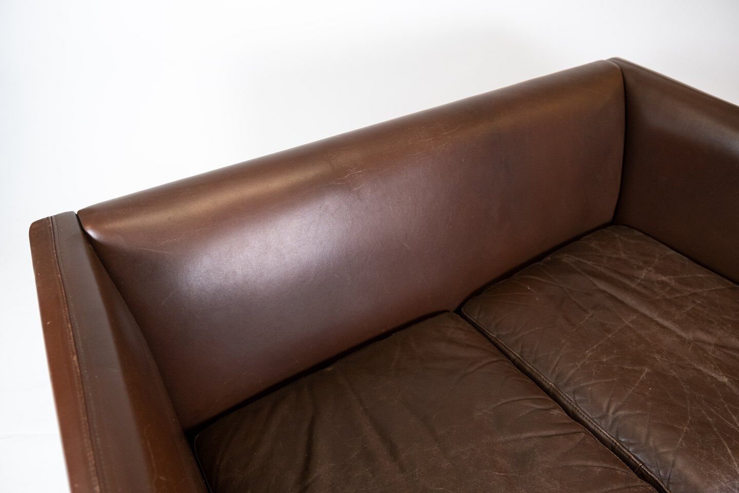 Two seater sofa upholstered with dark brown leather of danish design , by Stouby Furniture