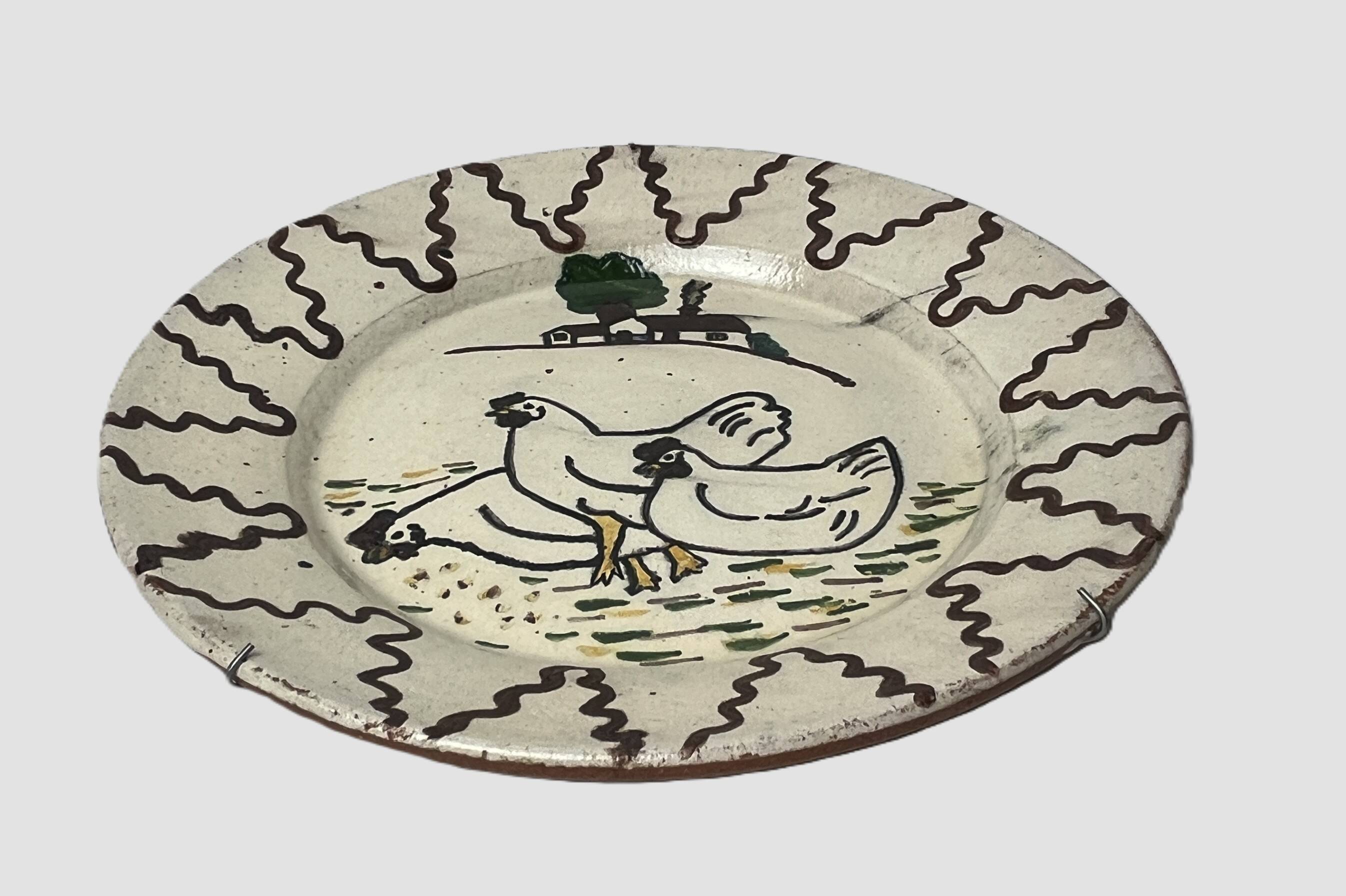 Old terracotta plate decorated with chickens, Portugal, 20th century.