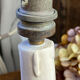 Candle holder-style lamp made entirely of ceramic.