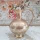 Chiseled brass pitcher decorated foliage