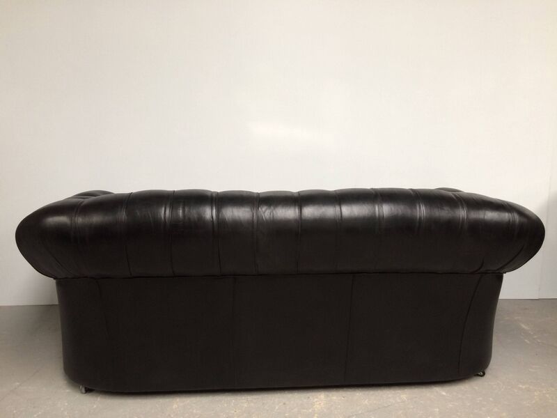 Three-seater black leather chesterfield sofa