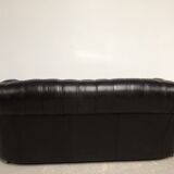 Three-seater black leather chesterfield sofa