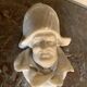 Marble sculpture, man's head in a hat.
