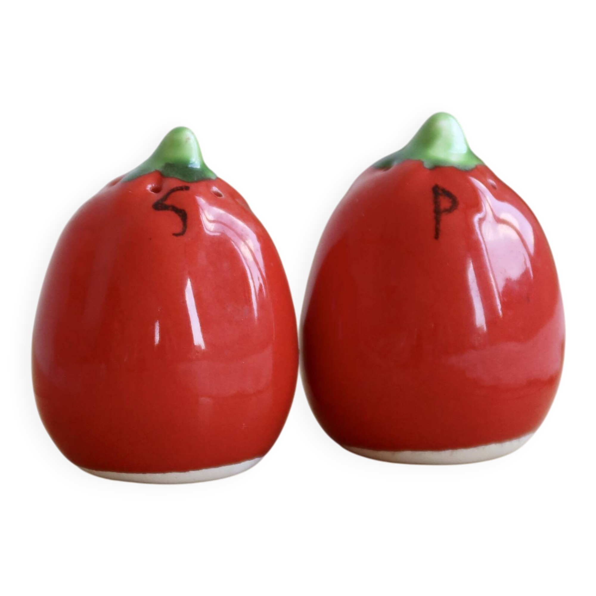 Vintage salt and pepper shakers in red tomato-shaped earthenware.