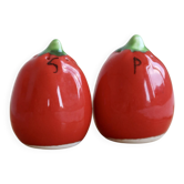 Vintage salt and pepper shakers in red tomato-shaped earthenware.