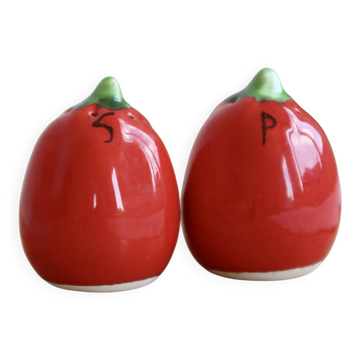 Vintage salt and pepper shakers in red tomato-shaped earthenware.