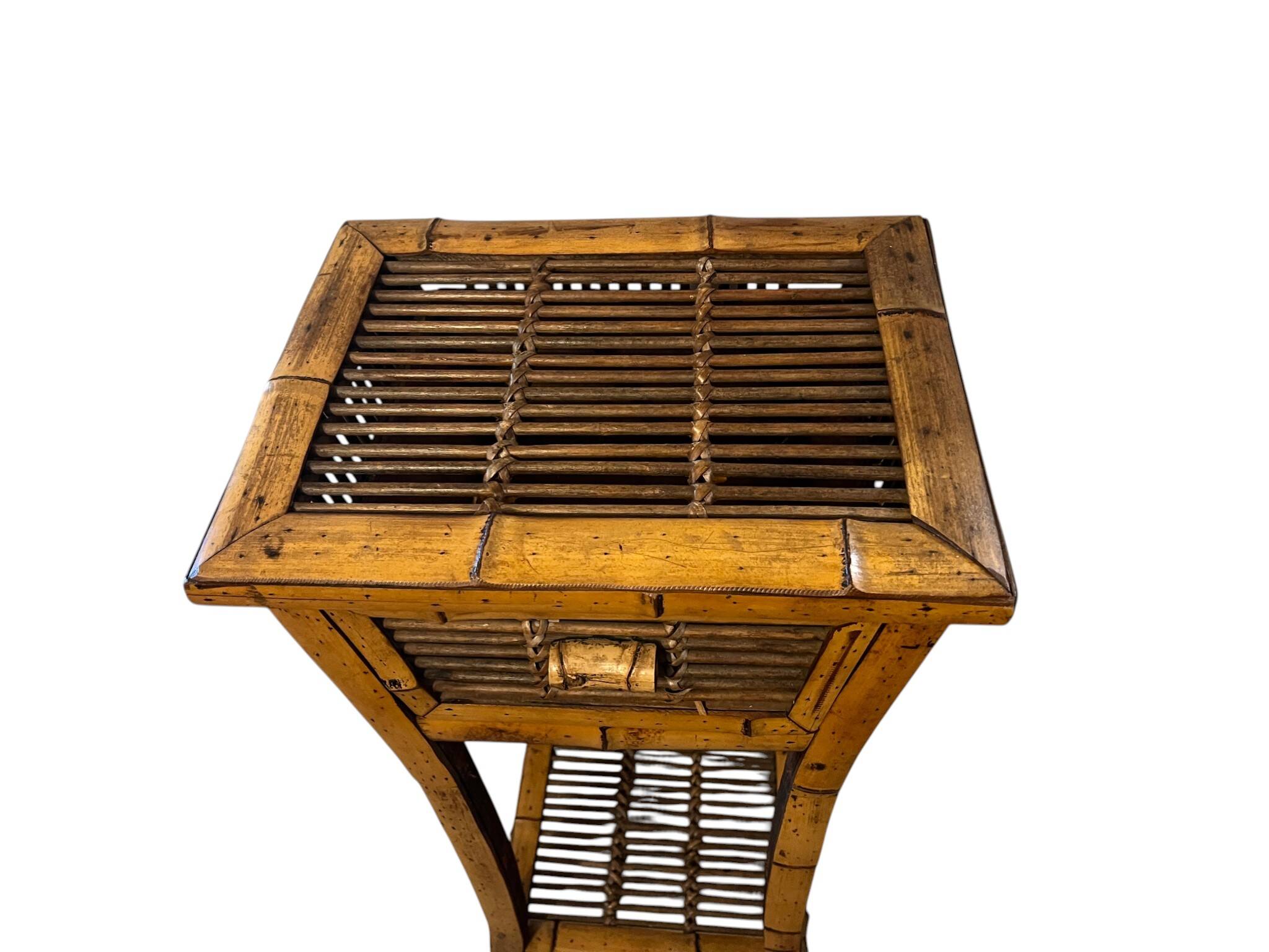 Vintage bamboo side table with drawer from the 20th century.