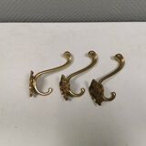 Three old and beautiful brass hooks with decorative motifs