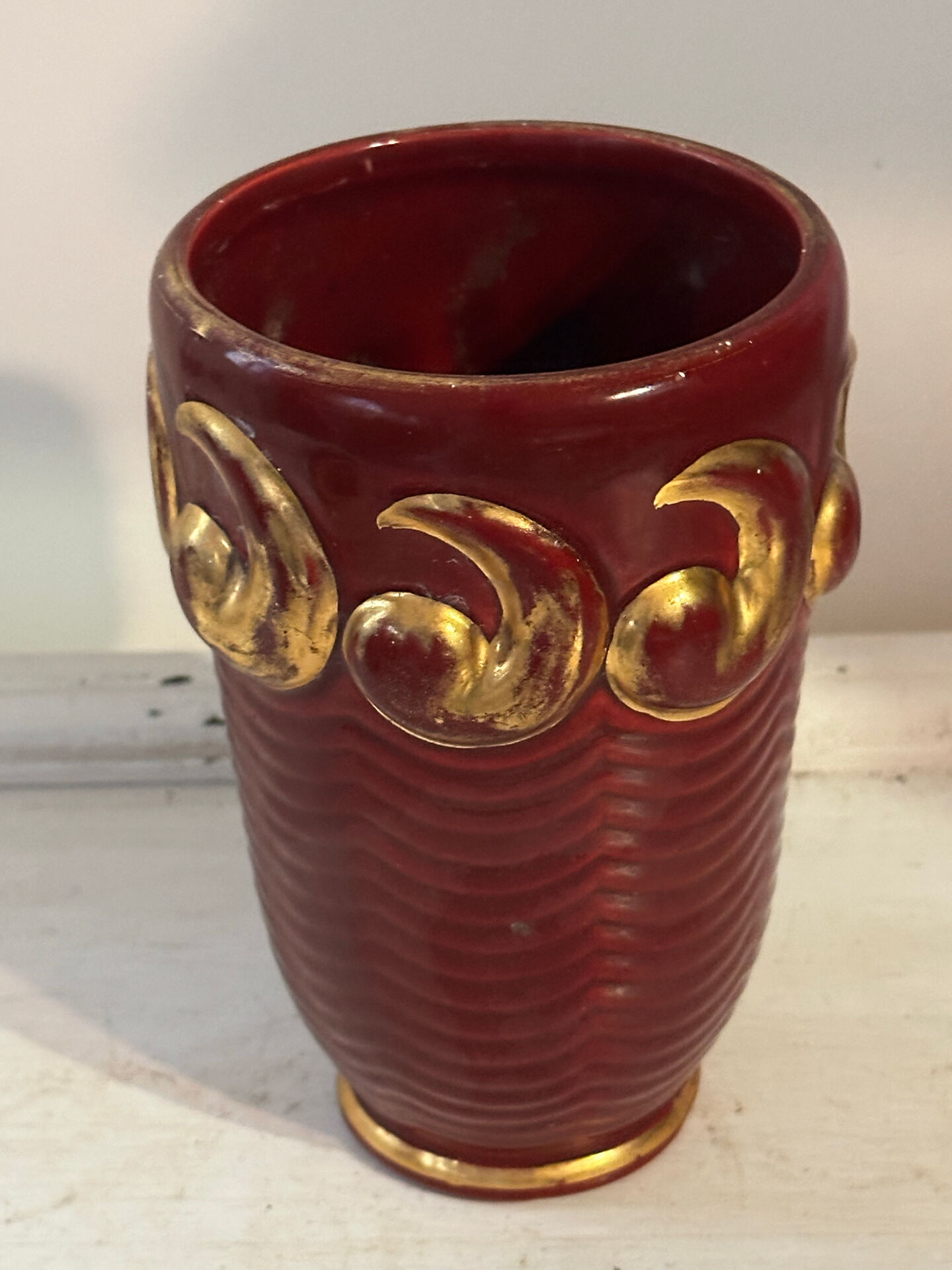 Mid-century relief vase in ruby red enhanced with gilding.