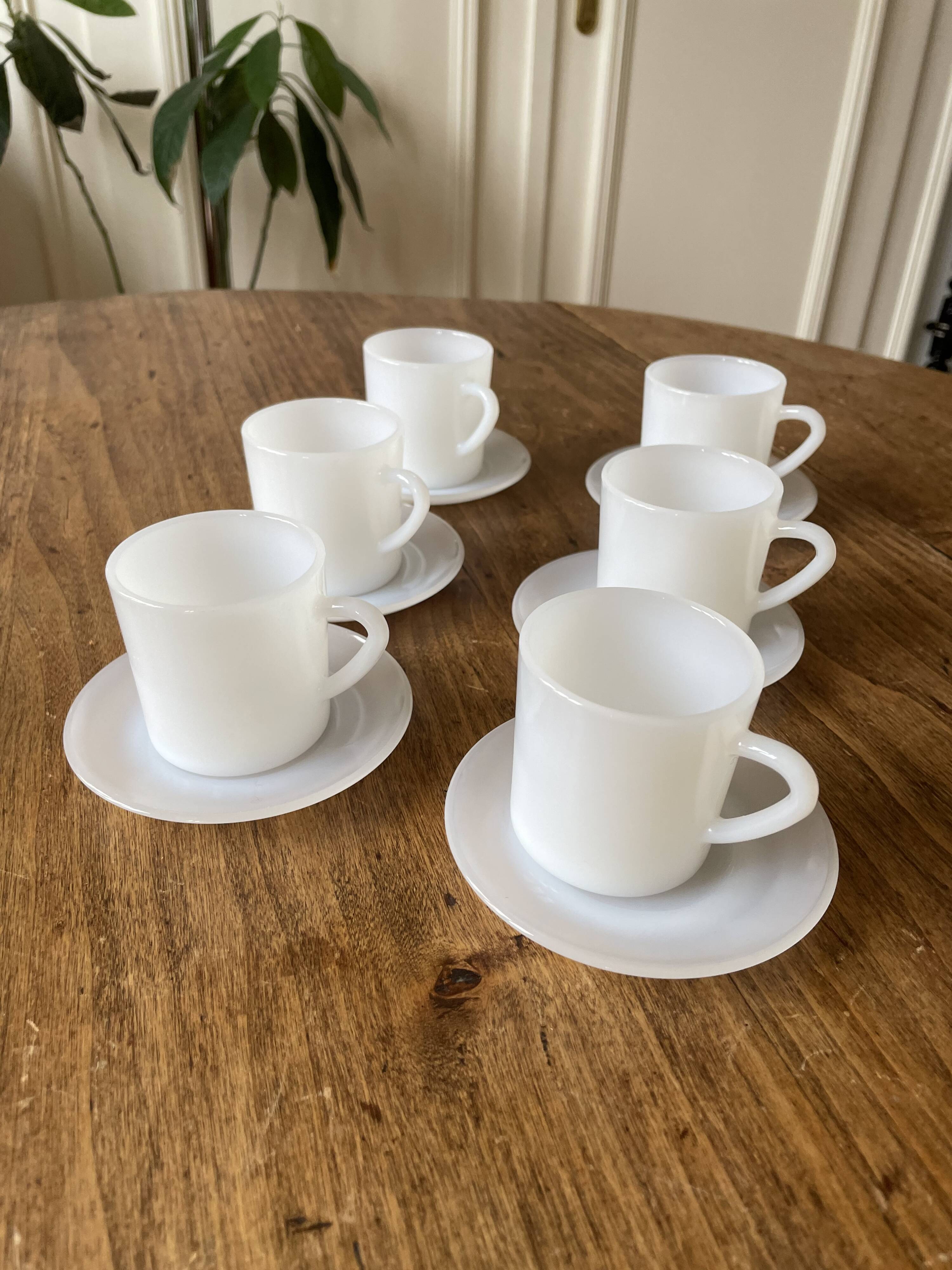 Espresso coffee cup service, Nestlé promotional items, in white glass.