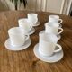 Espresso coffee cup service, Nestlé promotional items, in white glass.