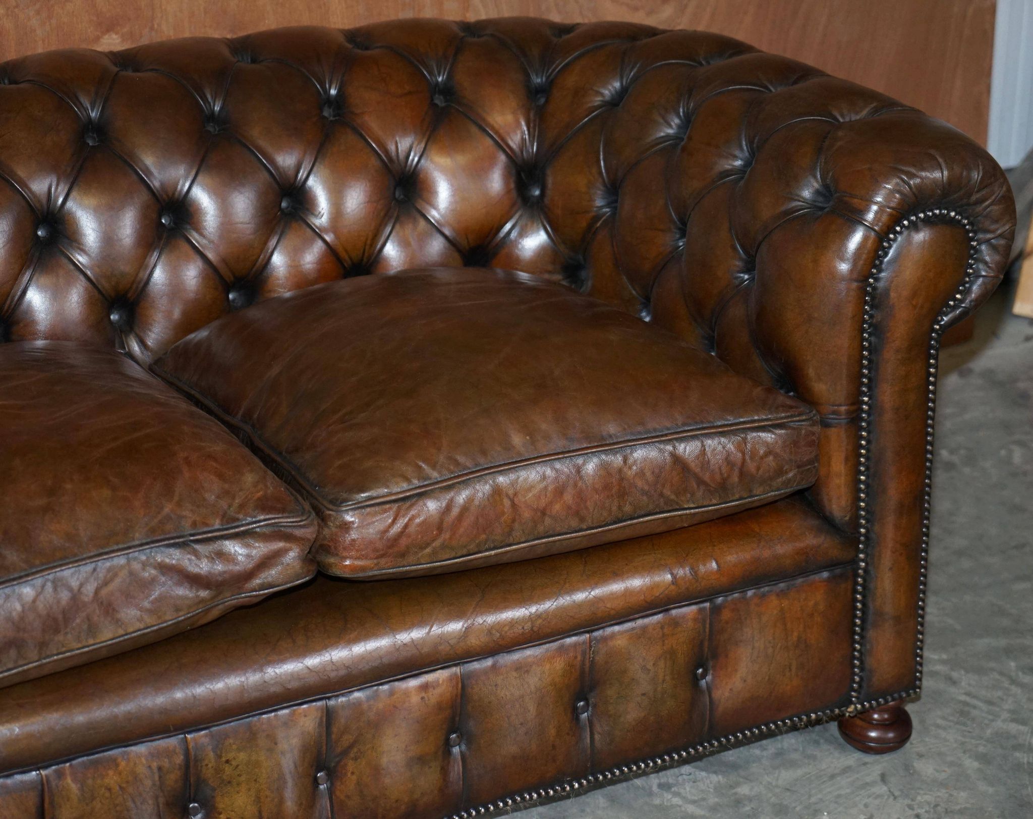 Restored leather Chesterfield sofa, walnut legs.