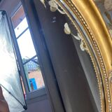 Oval-shaped gilded wooden mirror