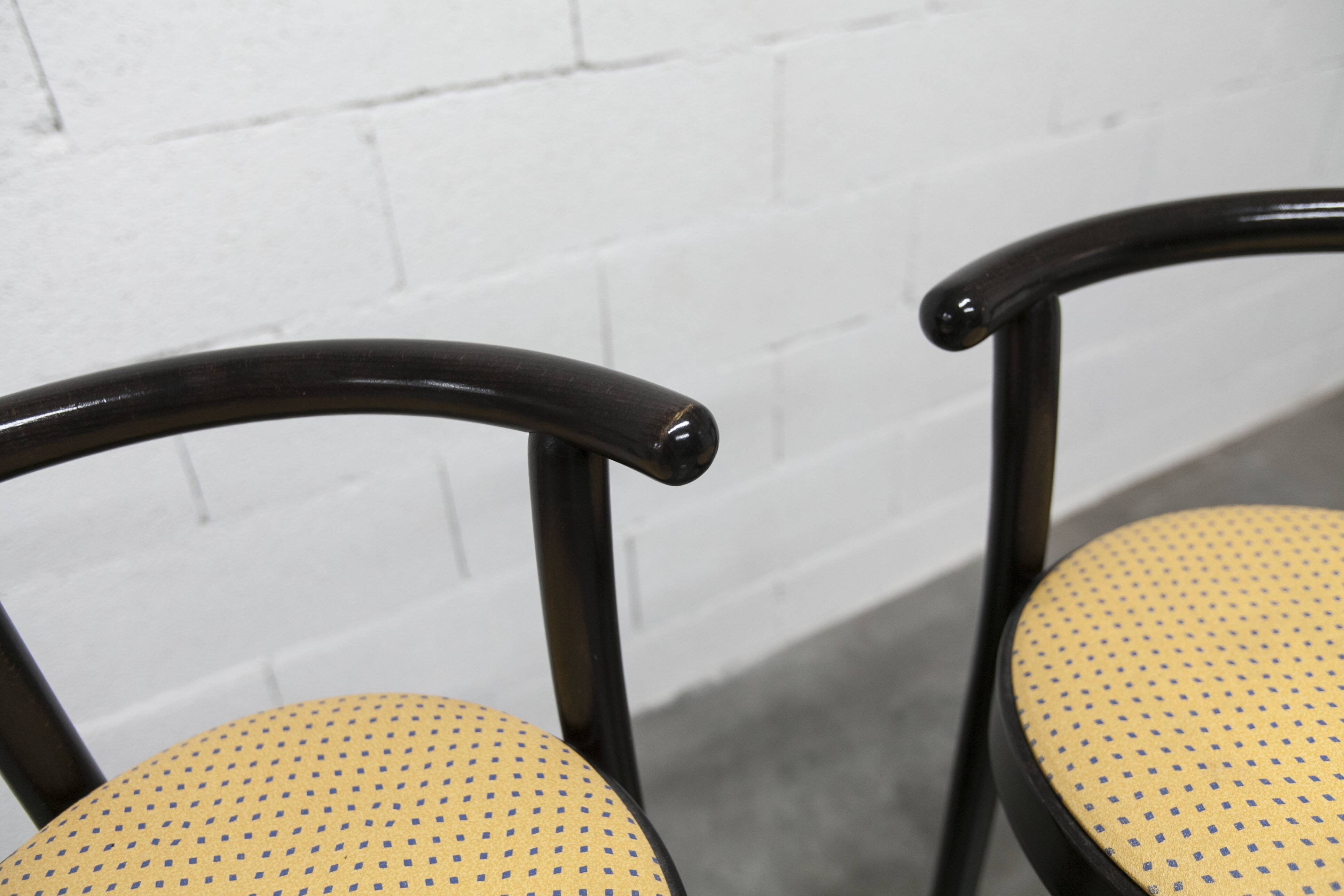 Pair of Baumann Dialog model stools in black and yellow and blue imitation leather, 1990