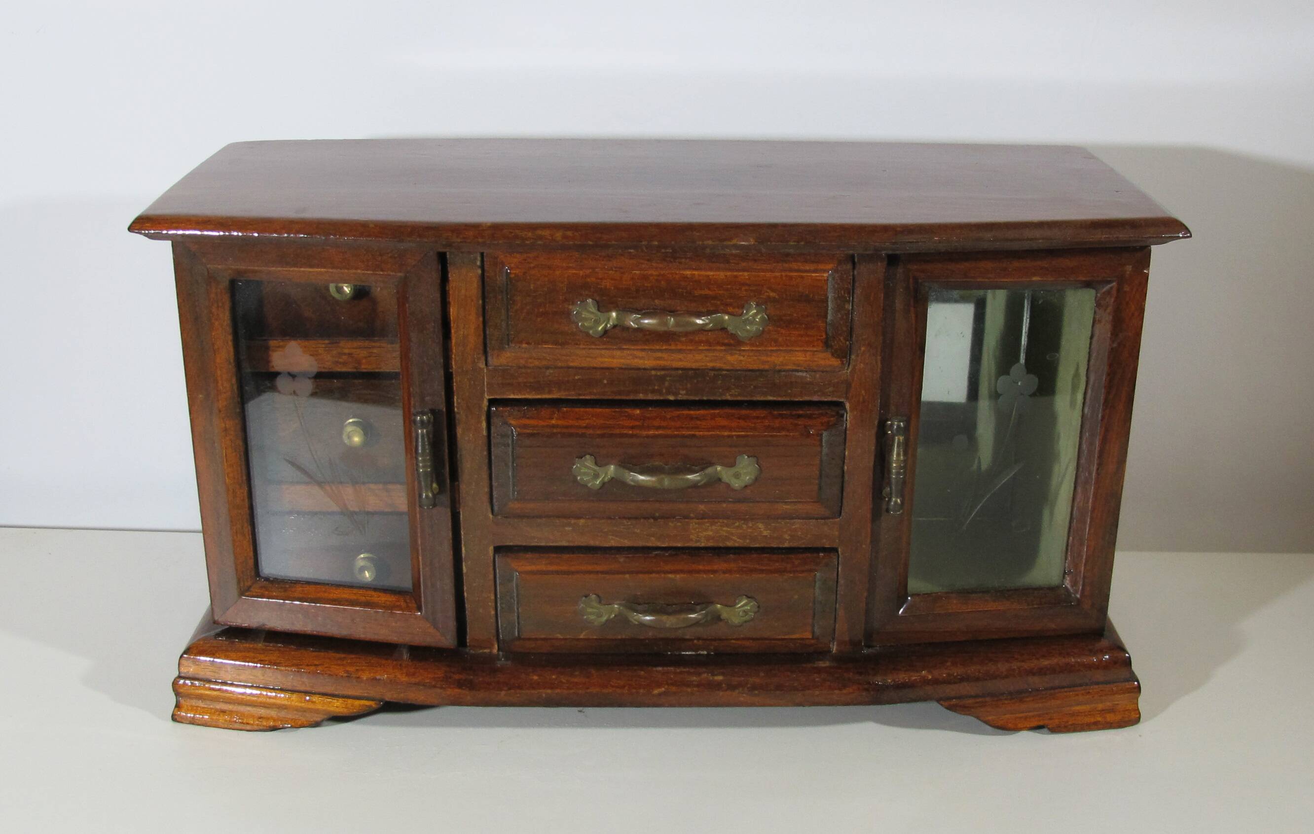 Wooden jewelry box in the shape of a dresser