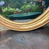 Golden oval mirror