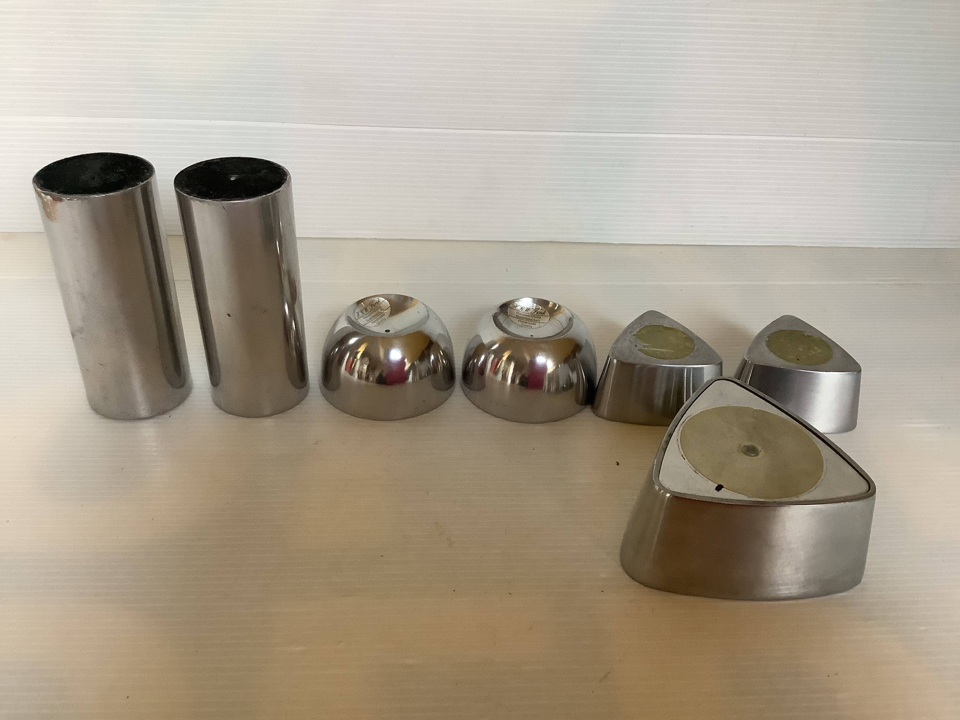 Seven different metal candle holders