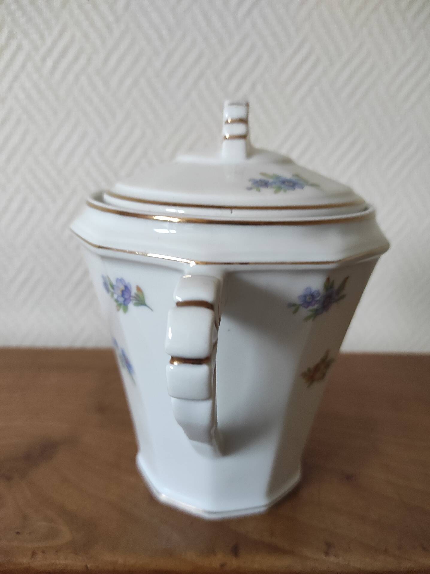 Antique porcelain sugar bowl with a decagonal base.
