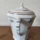 Antique porcelain sugar bowl with a decagonal base.