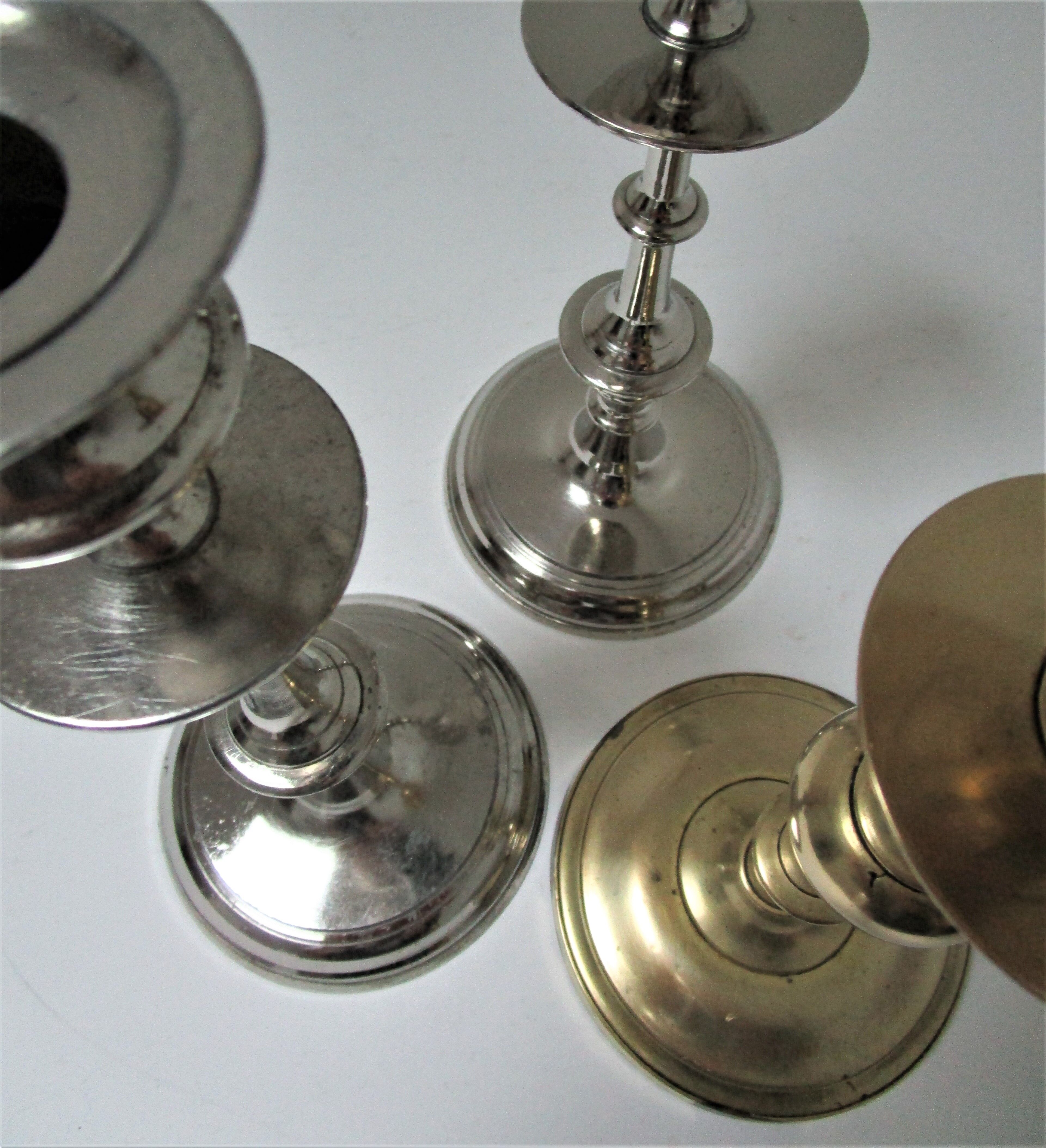 three brass and chrome candle holders early twentieth century