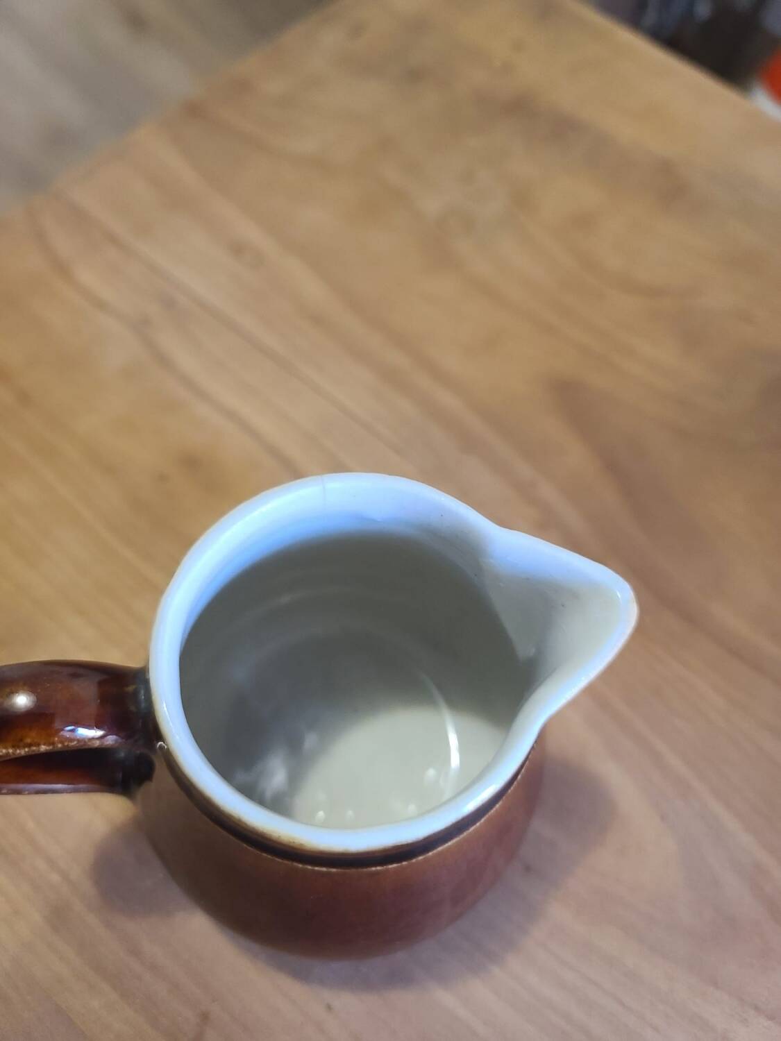 Brown ceramic milk jug