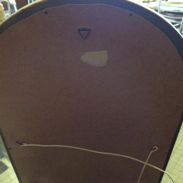 Wooden mirror and gilded stucco