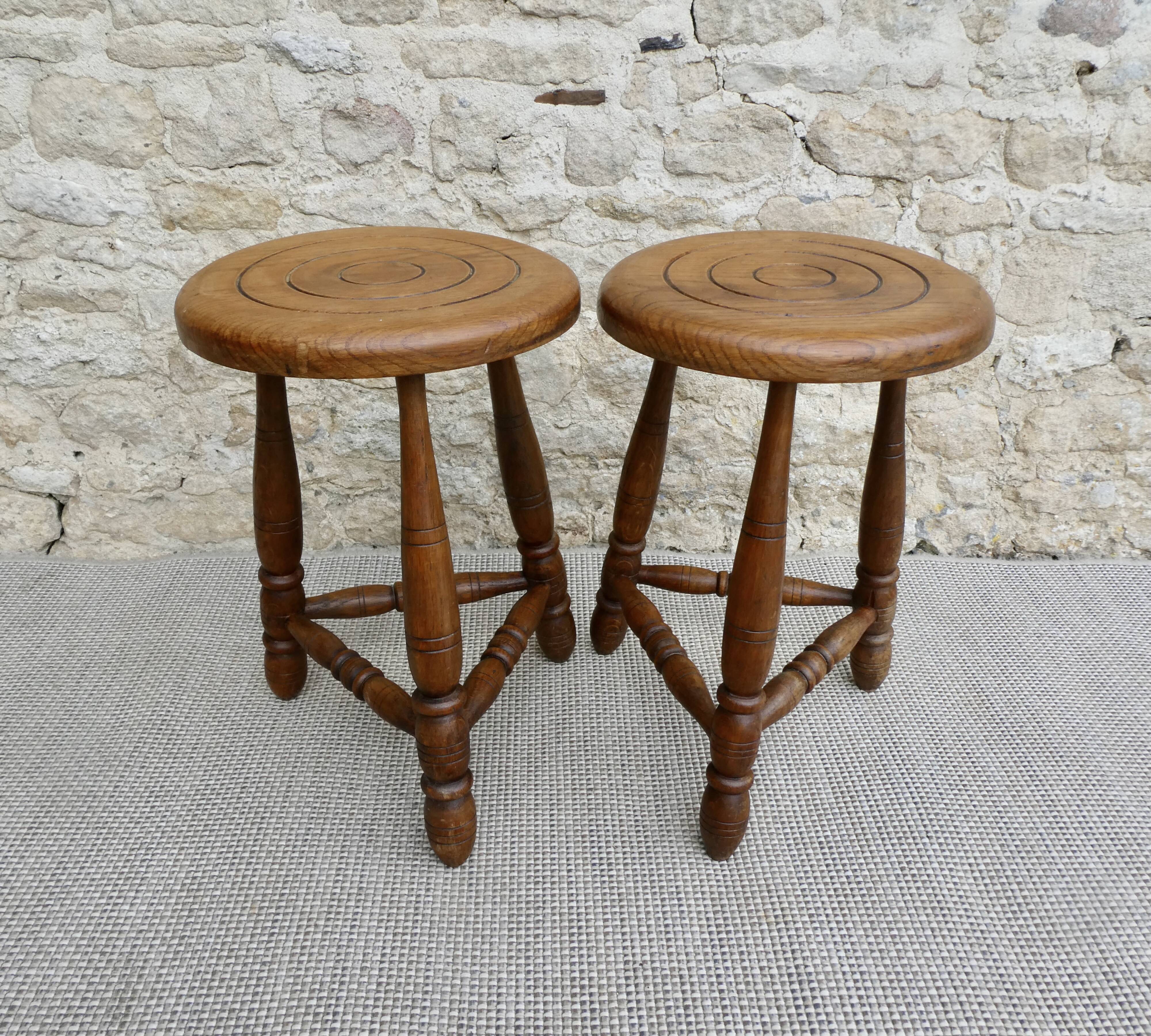 Pair of solid wood tripod stools, carved.