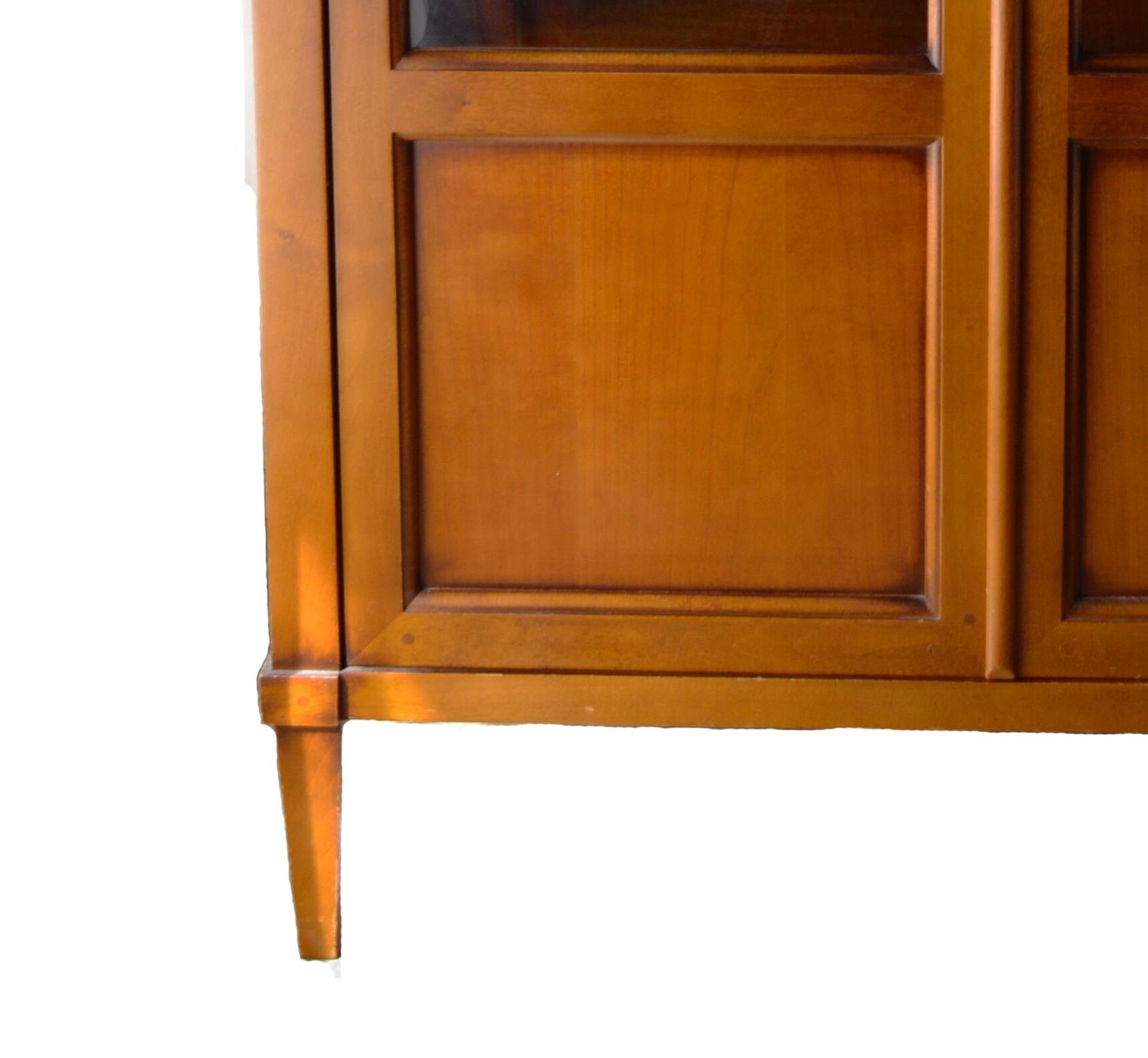 Straight molded clear wood cornice cabinet opening to two glass doors resting on  four sheath feet.