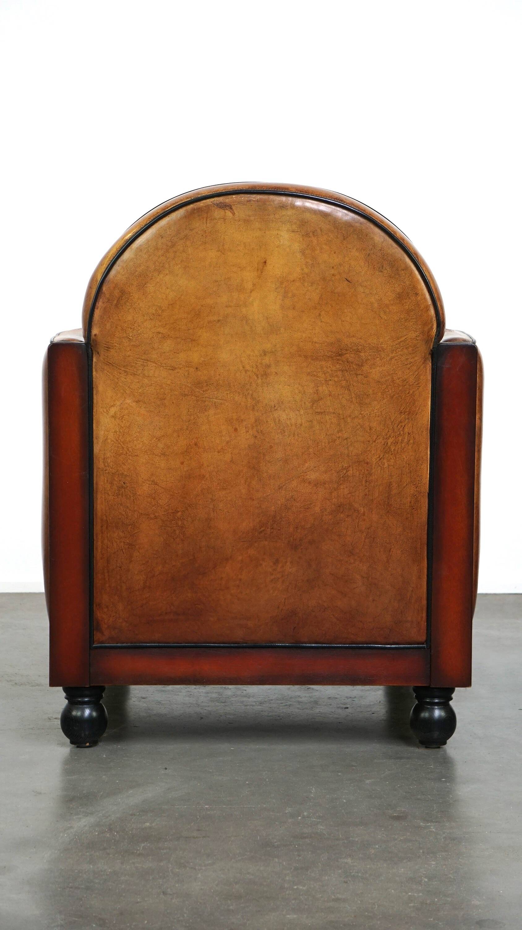 Sheepskin Art Deco design armchair with wood and beautiful cognac-colored leather