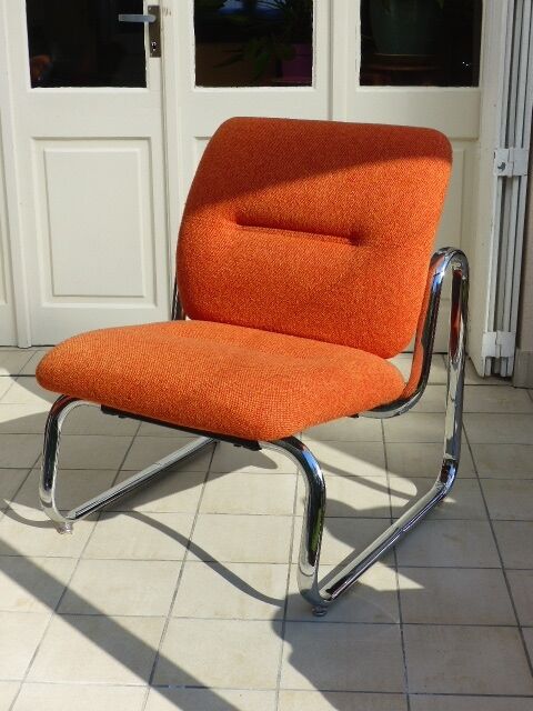 The 1970s orange armchair fabric and chrome metal