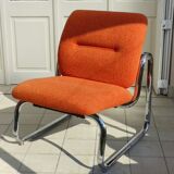 The 1970s orange armchair fabric and chrome metal