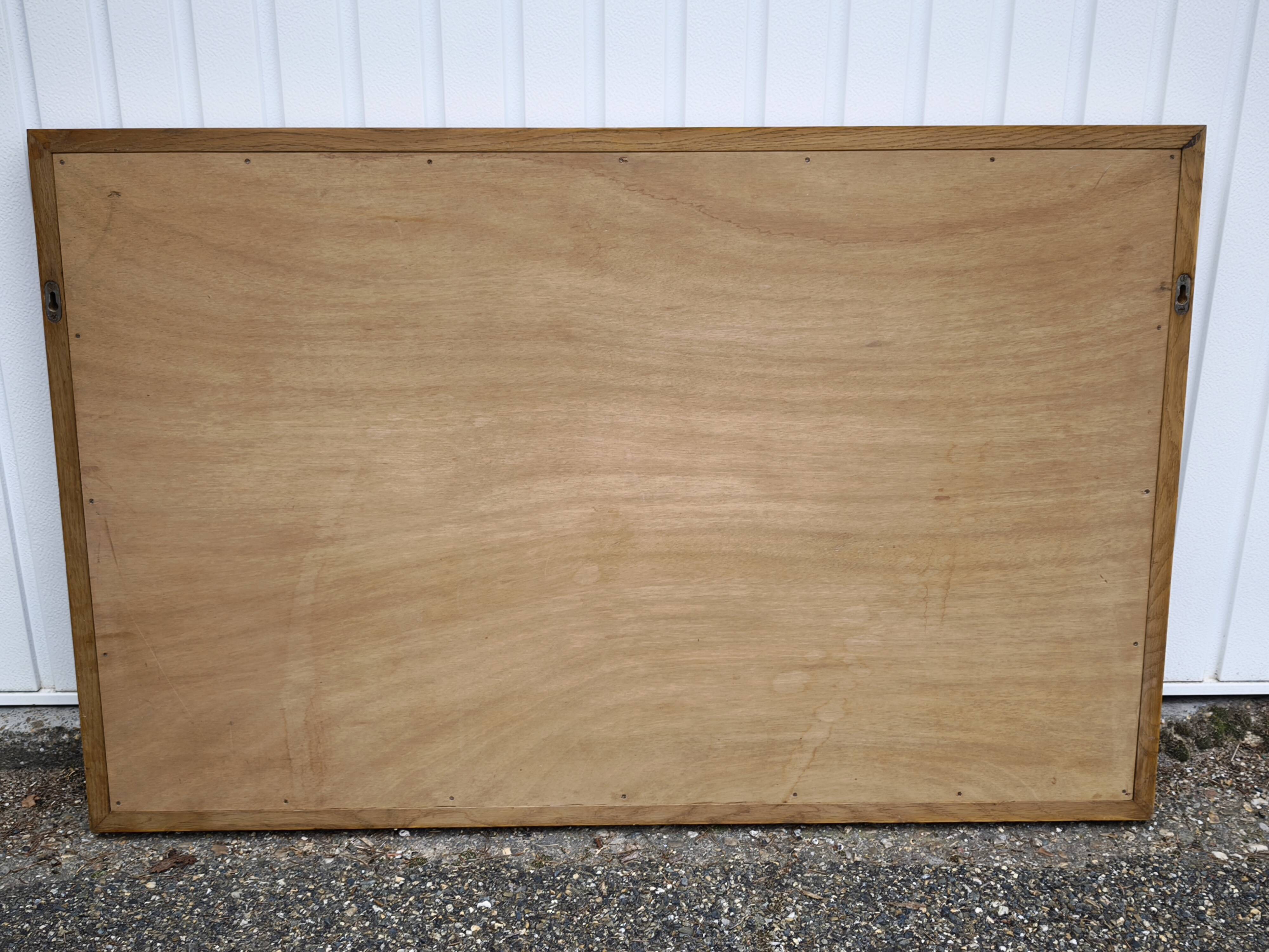 Large antique mirror with an oak frame.