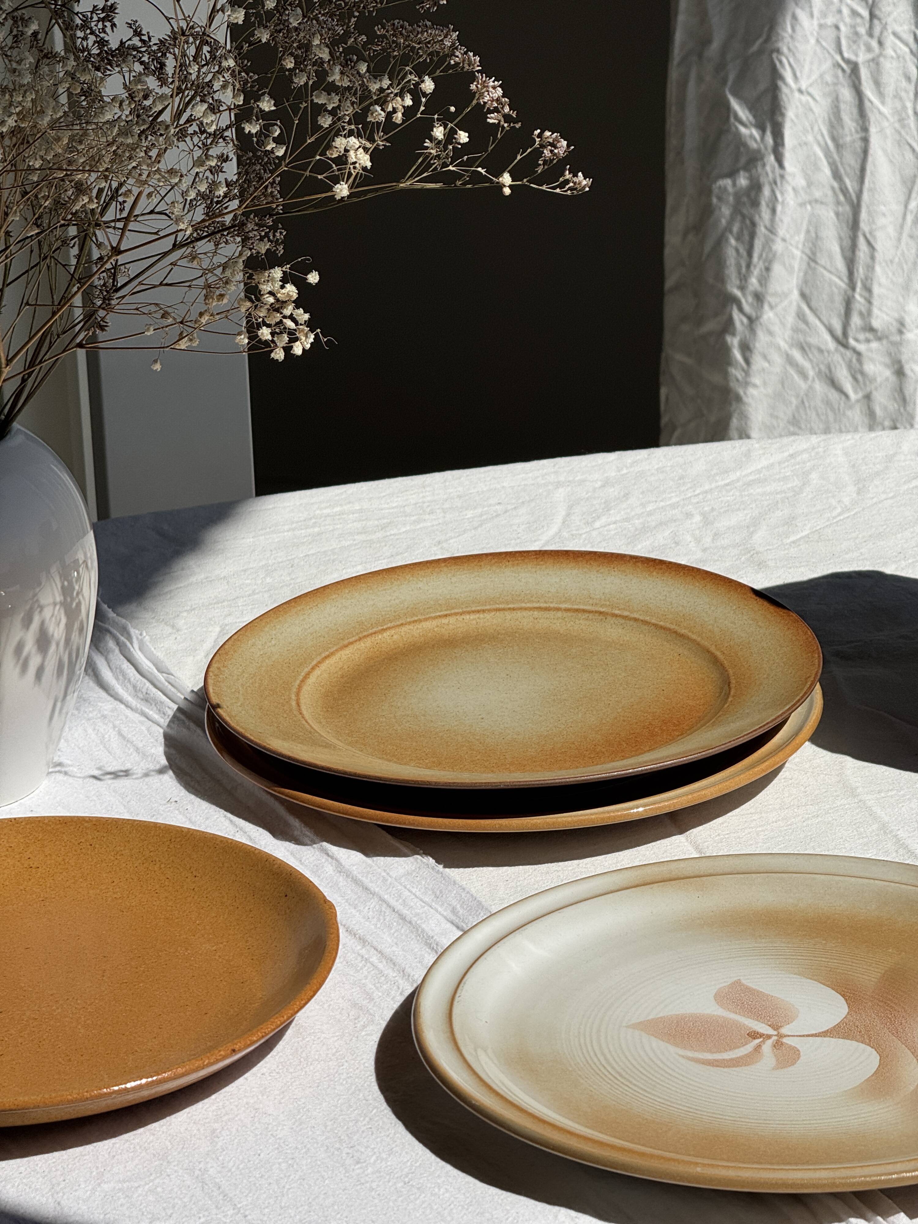 Set of 4 vintage stoneware plates, including 2 with floral motifs