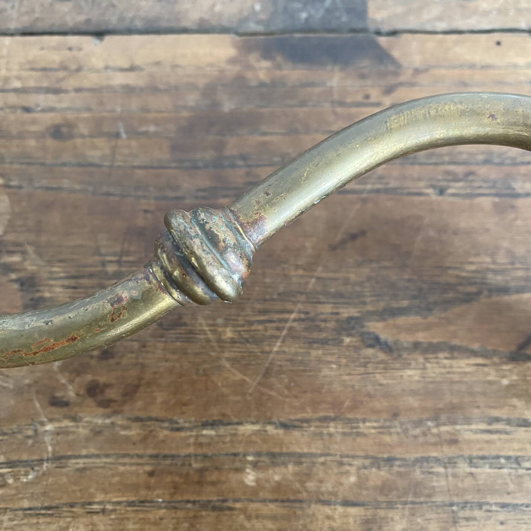 Antique swan neck wall light in brass and porcelain with a glass shade.