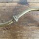 Antique swan neck wall light in brass and porcelain with a glass shade.