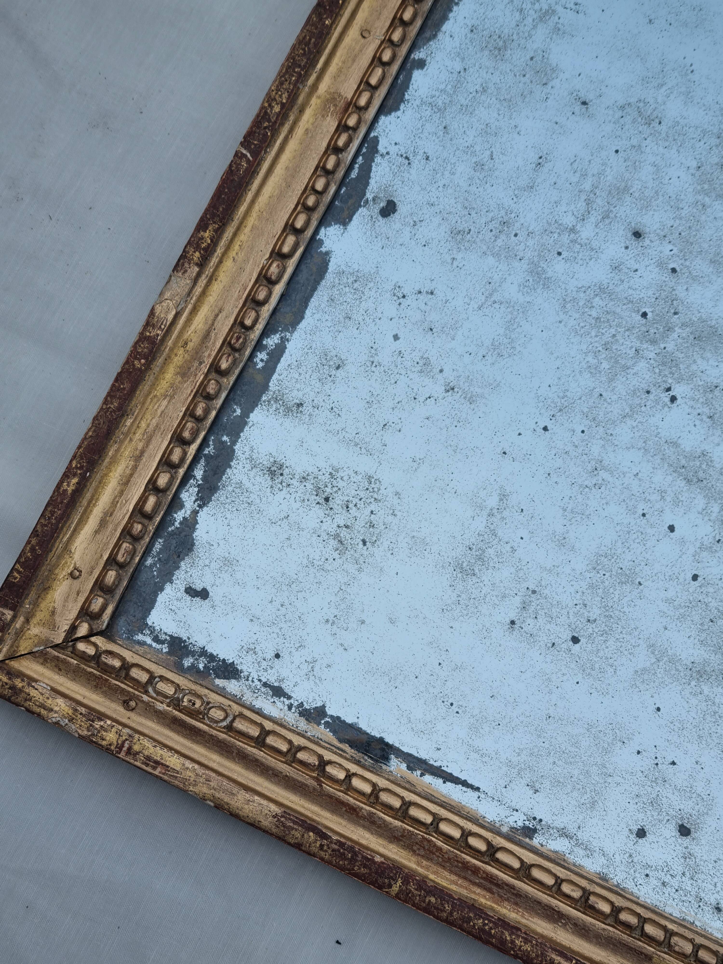 Antique mirror in a gilded wooden frame in the Louis XVI style, 19th century, 62x78 cm.